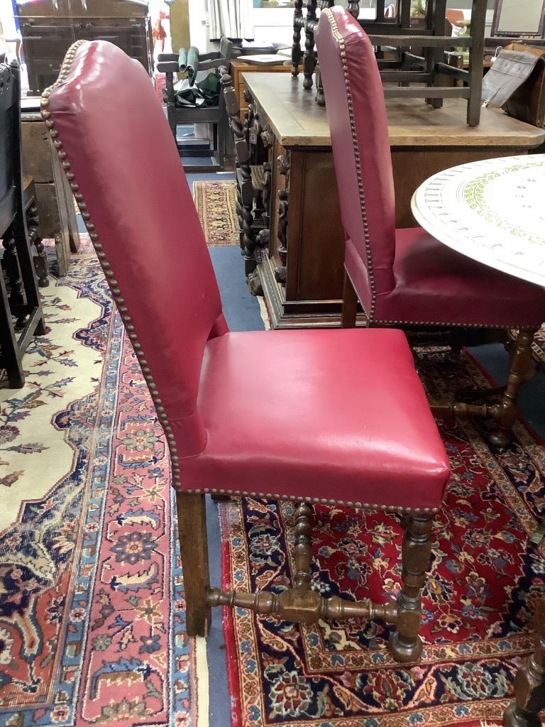 A set of six early 20th century Jacobean style oak high back dining chairs